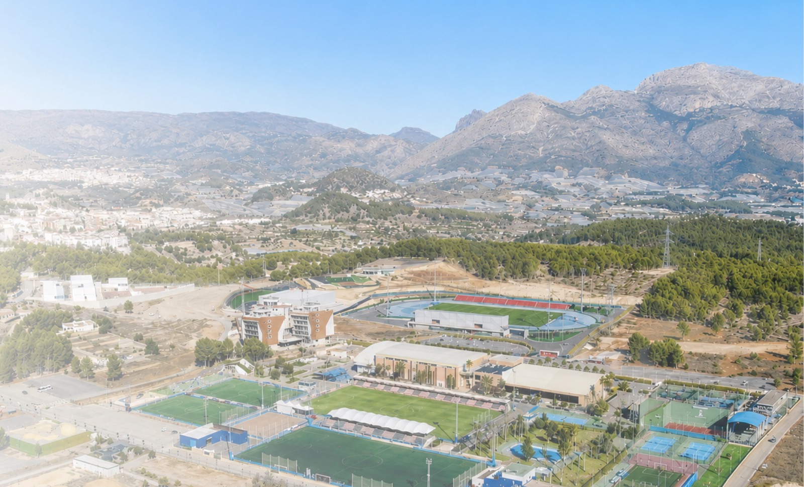 Aerial view of La Nucía Sports City, its pitches and facilities set against the Alicante mountains.